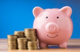 front-view-finance-elements-with-pink-piggy-bank-scaled-1